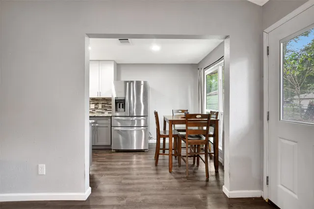 a kitchen with a table and chairs