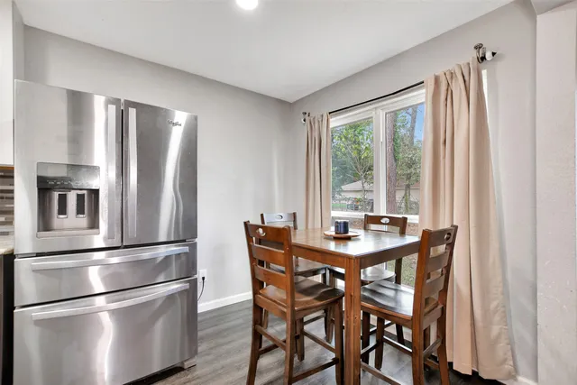 a kitchen with stainless steel appliances granite countertop a refrigerator and a stove top oven