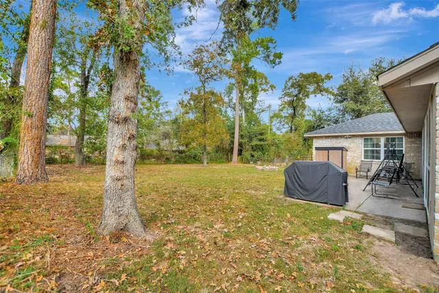 a view of a house with backyard and sitting area