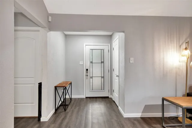 a view of a hallway with wooden floor and closet area