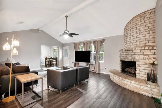 a living room with furniture a fireplace and a flat screen tv