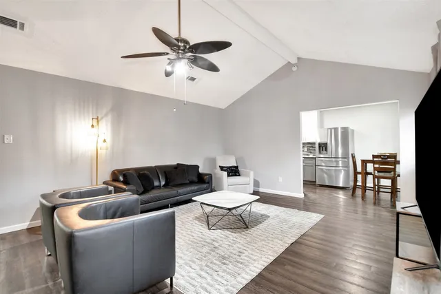 a living room with furniture and wooden floor