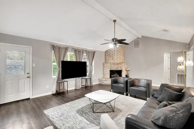 a living room with furniture and a flat screen tv