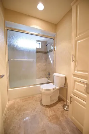 a bathroom with a toilet and a shower
