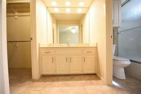 view of a bathroom with a glass door and a bathroom