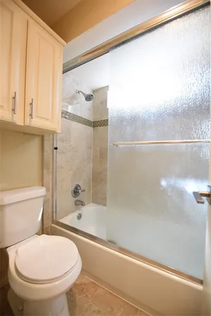 a bathroom with a toilet and a shower