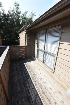 a balcony view with a wooden floor and roof deck
