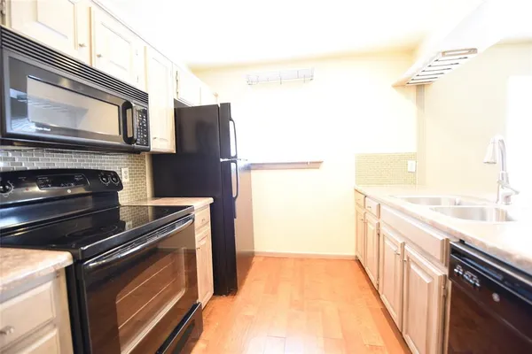a kitchen with stainless steel appliances a stove microwave and a refrigerator