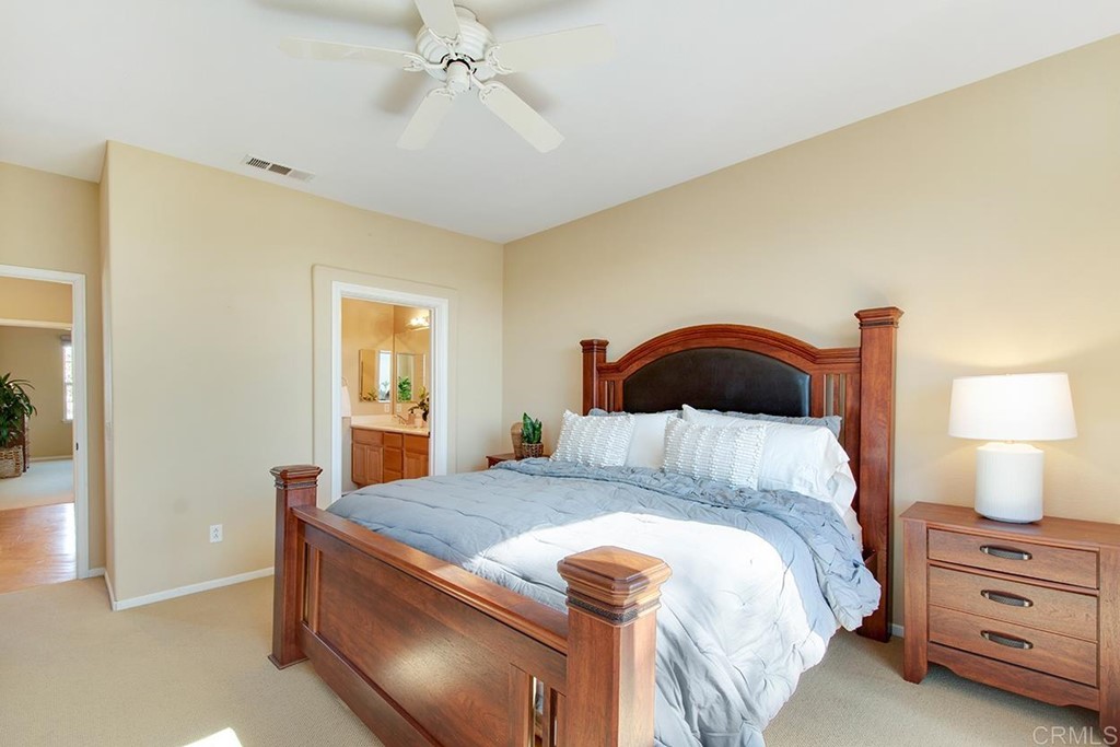 1723 Bluebird Lane Carlsbad, CA 92011 - Photo 21 of 33 a bedroom with a bed and a lamp