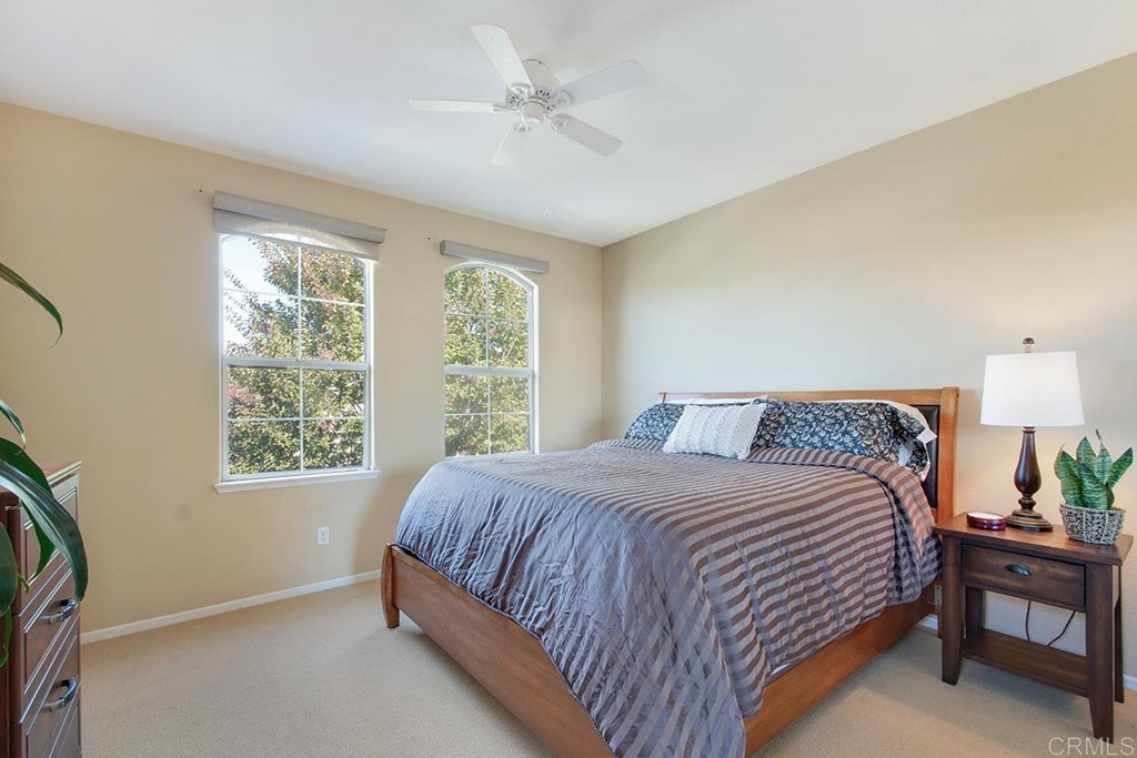 1723 Bluebird Lane Carlsbad, CA 92011 - Photo 25 of 33 a bedroom with a bed a chandelier and a window