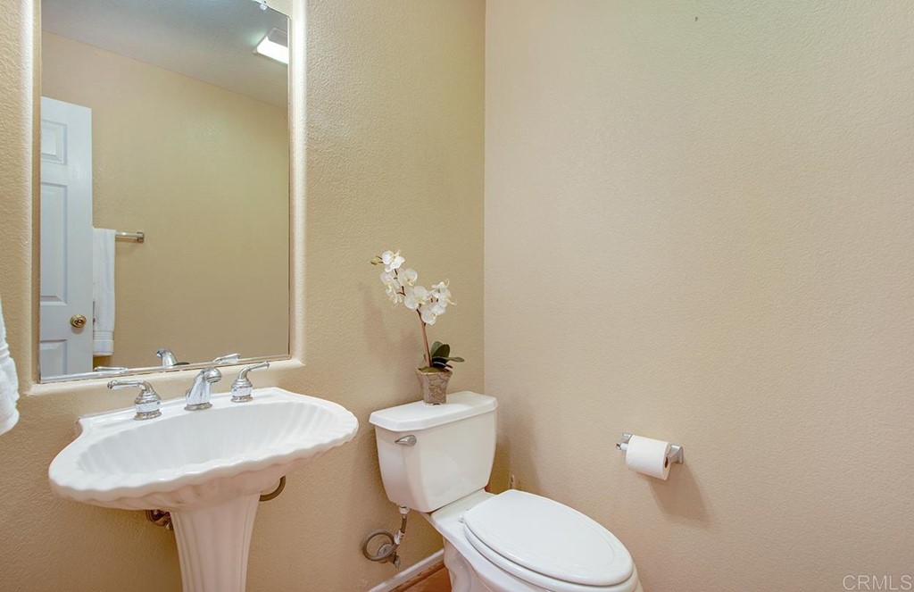 1723 Bluebird Lane Carlsbad, CA 92011 - Photo 27 of 33 a bathroom with a sink mirror and toilet