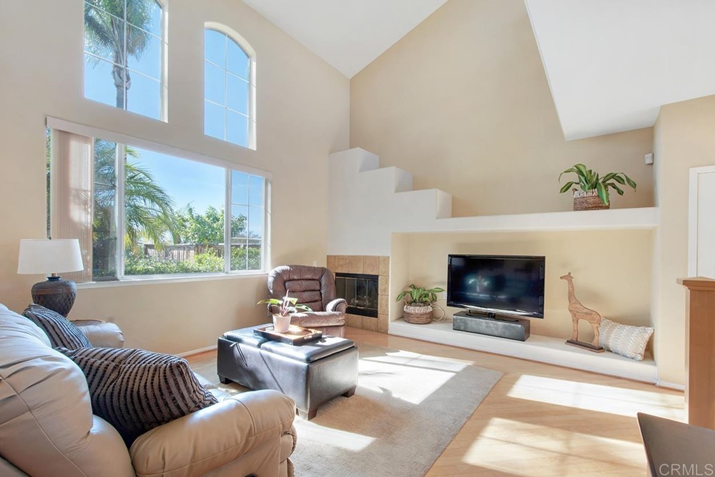 1723 Bluebird Lane Carlsbad, CA 92011 - Photo 3 of 33 a living room with furniture a flat screen tv and a fireplace