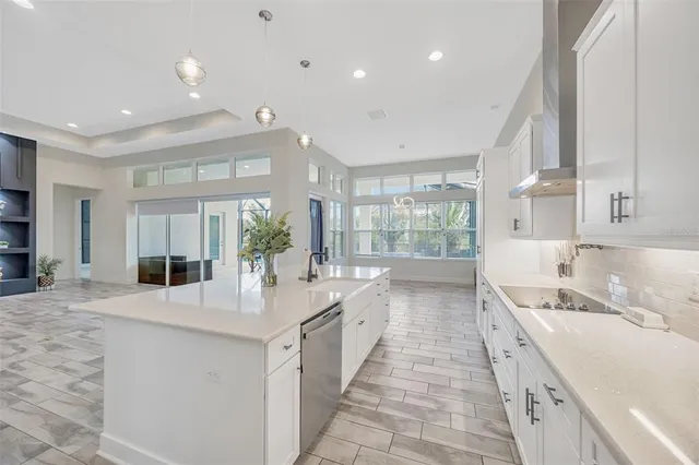 a large kitchen with kitchen island a sink stainless steel appliances and cabinets