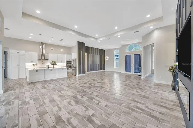 a view of a livingroom with furniture and an empty room