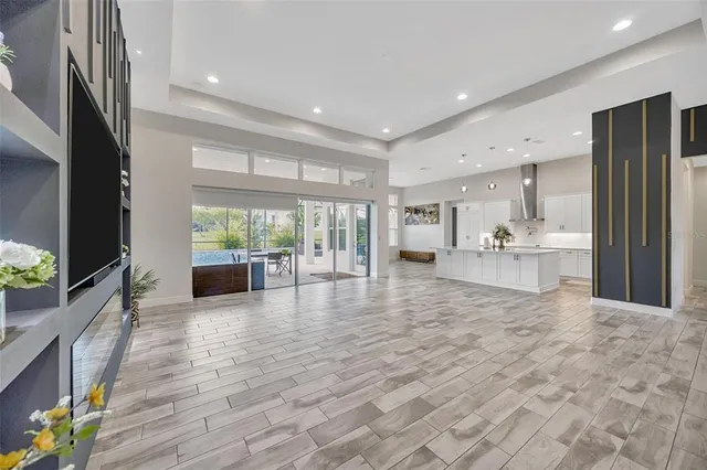 a view of a livingroom with wooden floor and window