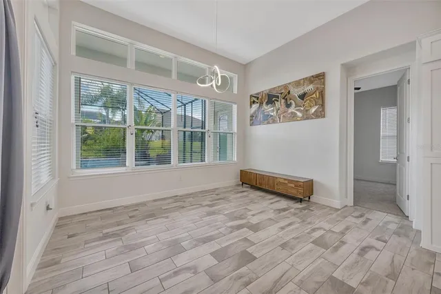 an empty room with windows and cabinet