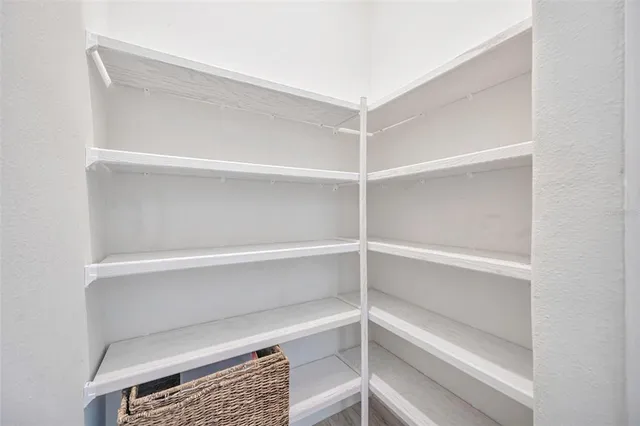 a white toilet sitting next to a bathroom sink and vanity