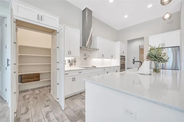 a large bathroom with a double vanity sink a large mirror and a bathtub