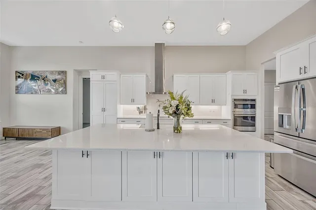 a large white kitchen with a large window