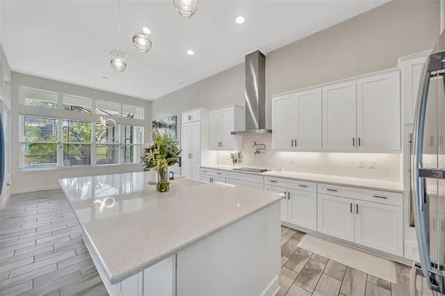 a large white kitchen with a large window