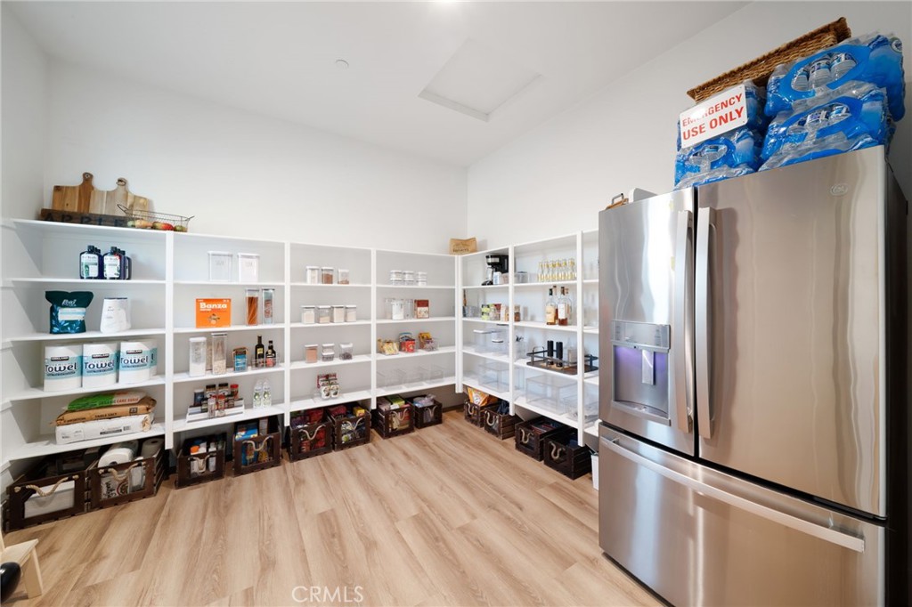 17042 Meteor Way Riverside, CA 92503 - Photo 16 of 75 a kitchen with stainless steel appliances a refrigerator and a wooden floor