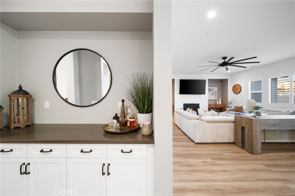17042 Meteor Way Riverside, CA 92503 - Photo 17 of 75 a living room with furniture a mirror and white walls