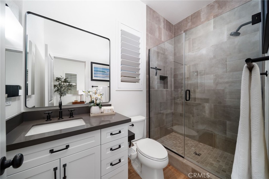 17042 Meteor Way Riverside, CA 92503 - Photo 34 of 75 a bathroom with a granite countertop sink toilet and shower