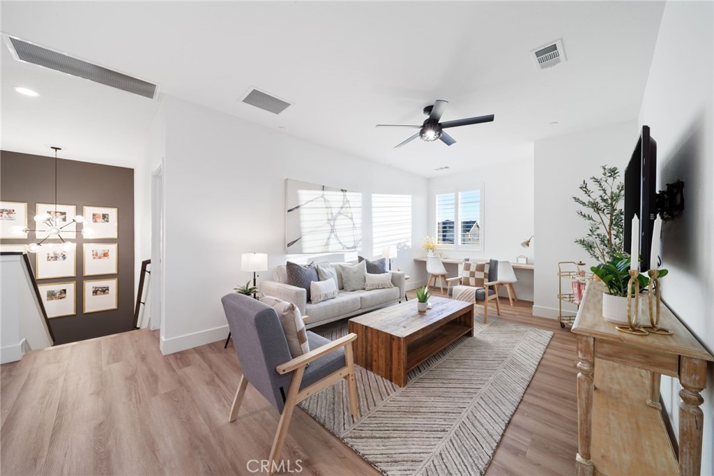 17042 Meteor Way Riverside, CA 92503 - Photo 37 of 75 a living room with furniture a flat screen tv and a large window