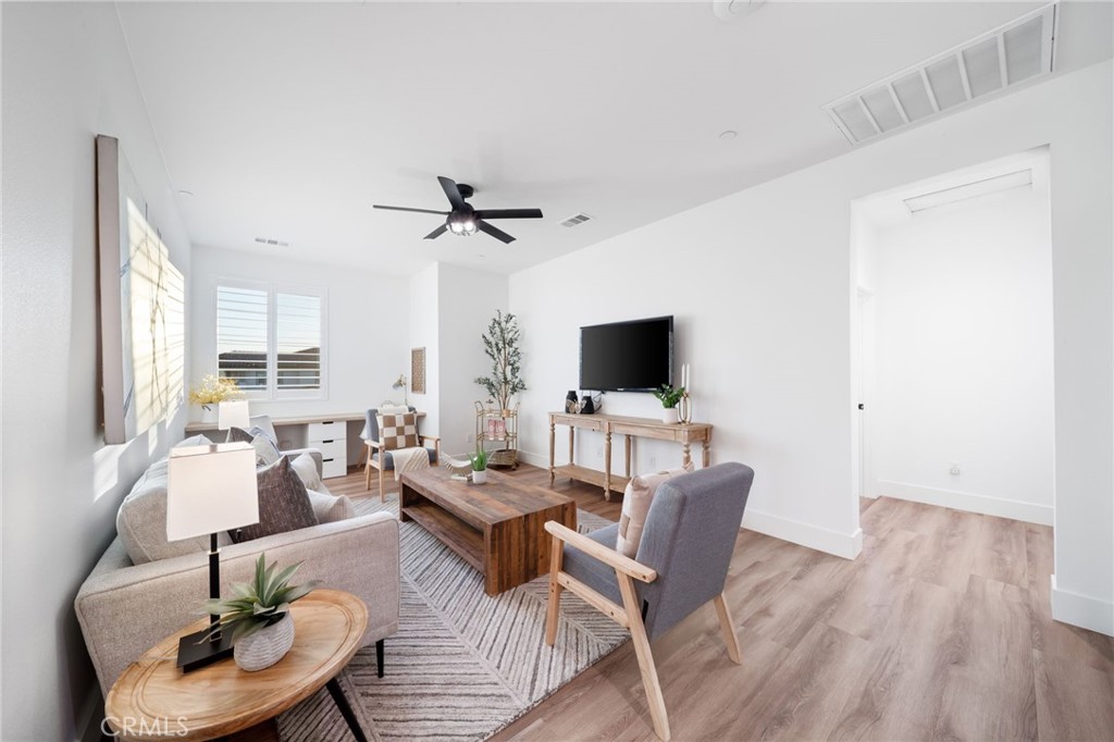 17042 Meteor Way Riverside, CA 92503 - Photo 38 of 75 a living room with furniture a flat screen tv and a large window