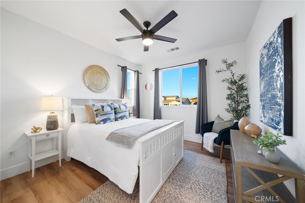 17042 Meteor Way Riverside, CA 92503 - Photo 43 of 75 a bedroom with a bed a chandelier and a dresser