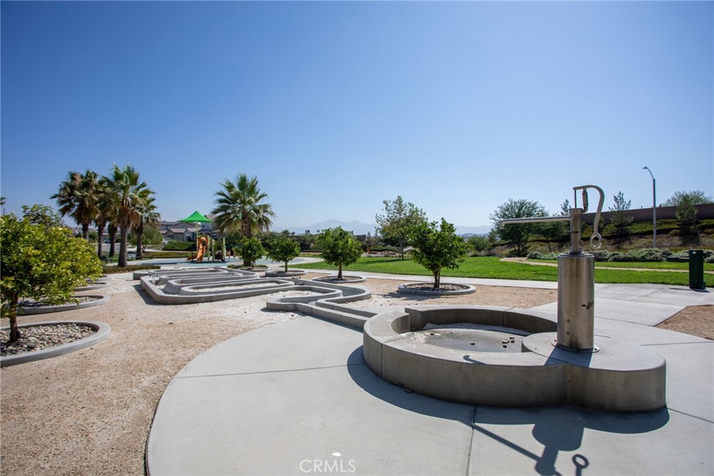 17042 Meteor Way Riverside, CA 92503 - Photo 71 of 75 a view of a swimming pool with a yard and palm trees