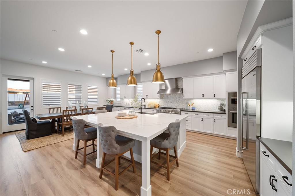 17042 Meteor Way Riverside, CA 92503 - Photo 10 of 75 a large kitchen with a table and chairs