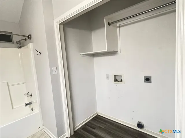 a bathroom with a shower and a sink