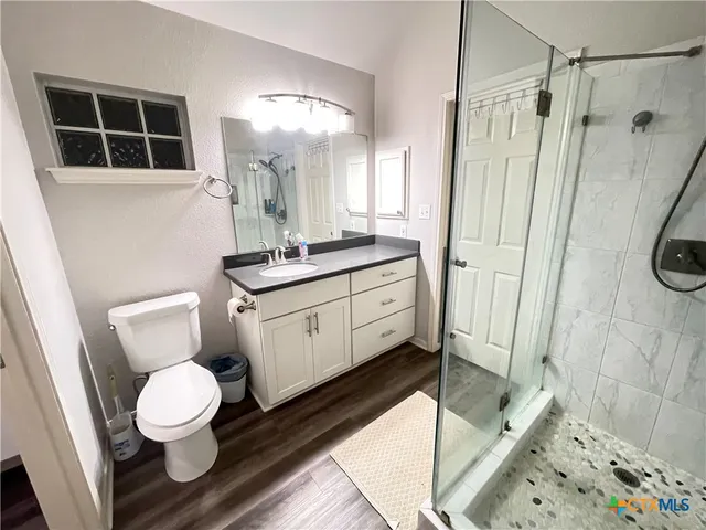 a bathroom with a toilet sink and a shower