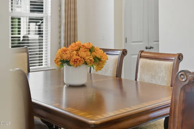 a kitchen with stainless steel appliances granite countertop wooden cabinets a refrigerator a stove a sink and a microwave oven with wooden floor