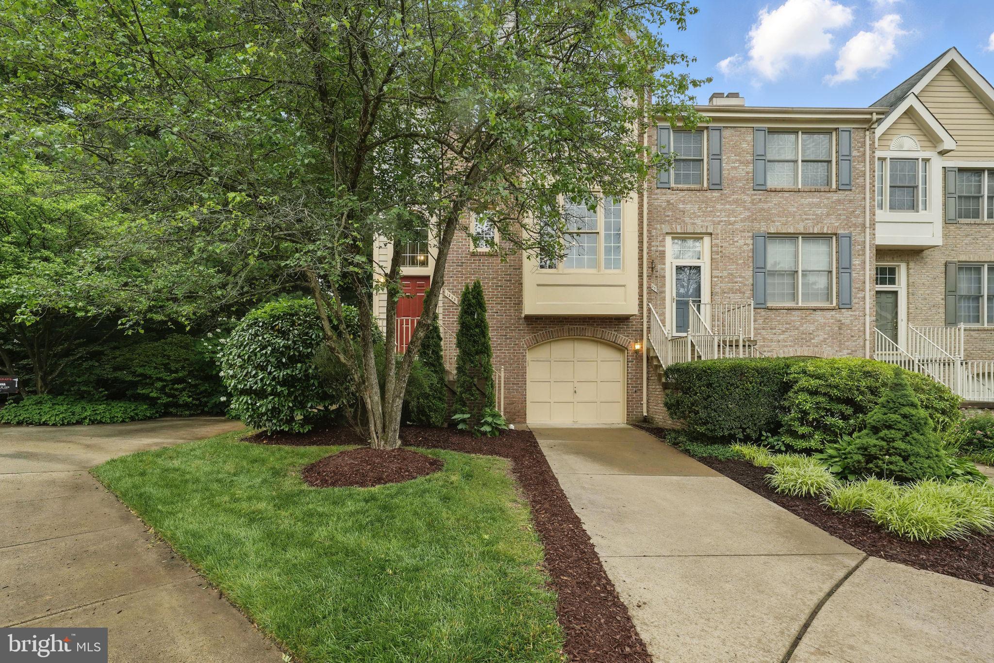 1393 Heritage Oak Way Reston, VA 20194 - Photo 1 of 80 a front view of a house with a yard and trees