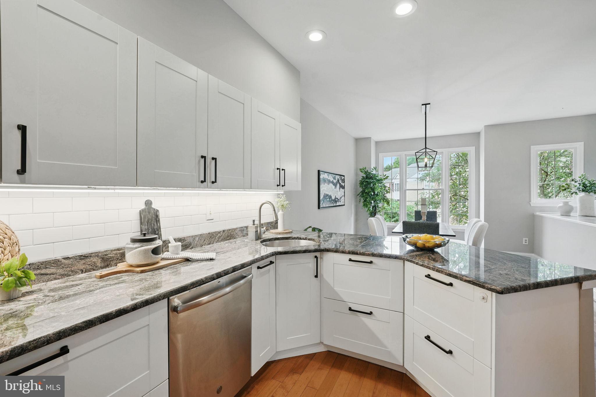 1393 Heritage Oak Way Reston, VA 20194 - Photo 16 of 80 a kitchen with granite countertop a sink stainless steel appliances white cabinets and a window