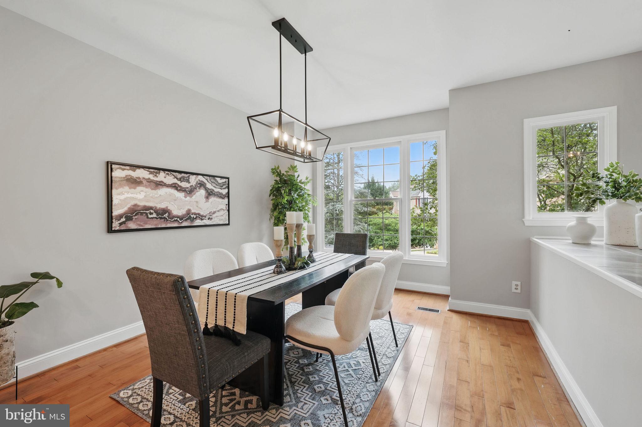 1393 Heritage Oak Way Reston, VA 20194 - Photo 21 of 80 a dining room with furniture a chandelier and wooden floor
