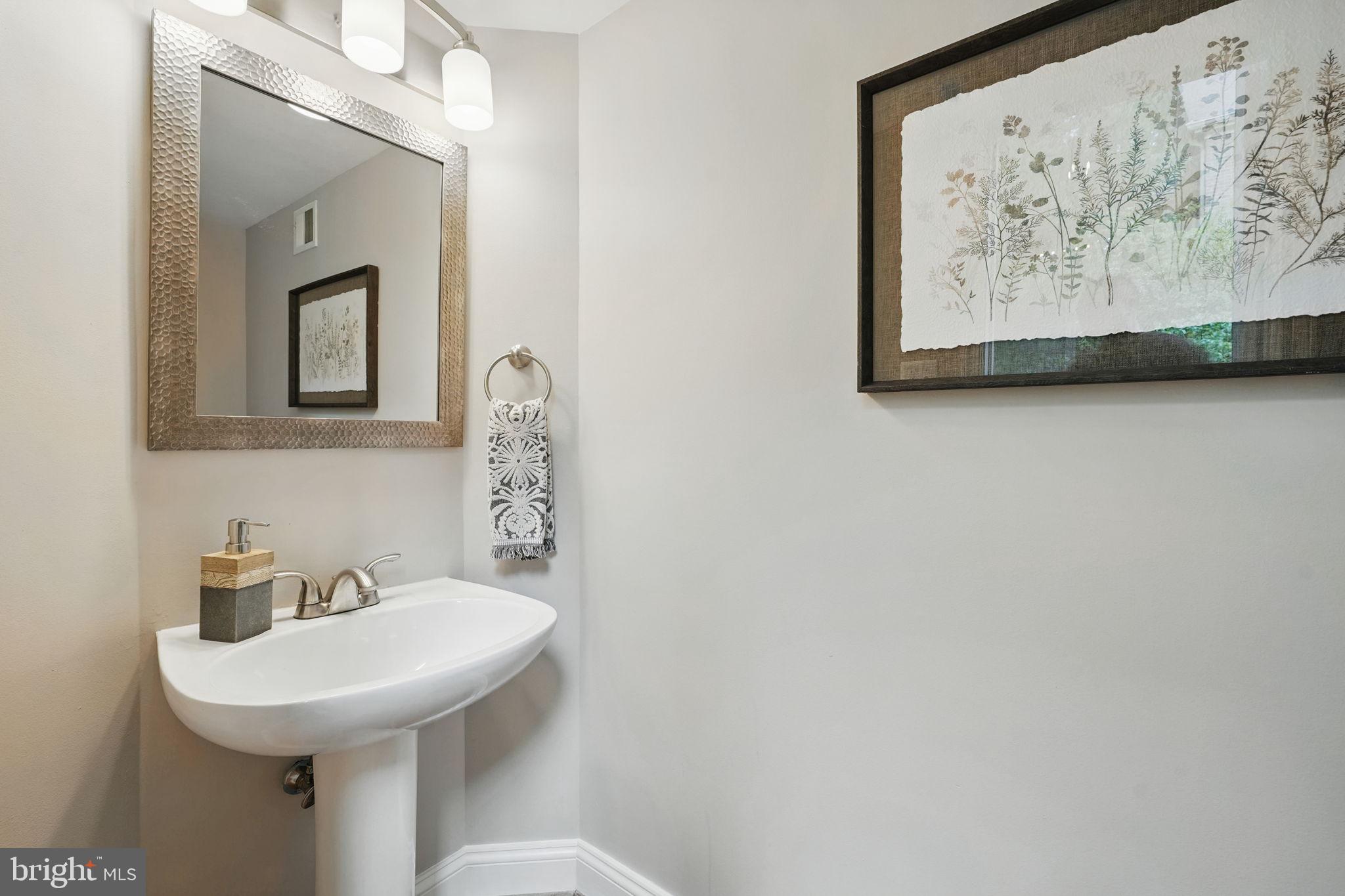 1393 Heritage Oak Way Reston, VA 20194 - Photo 22 of 80 a bathroom with a toilet sink and mirror