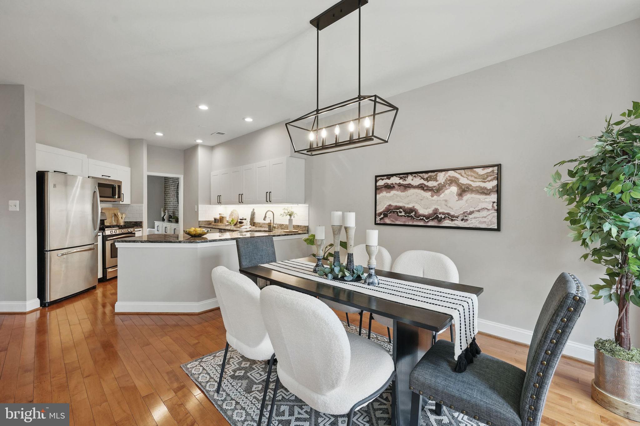 1393 Heritage Oak Way Reston, VA 20194 - Photo 25 of 80 a dining room with wooden floor a chandelier a glass table and chairs