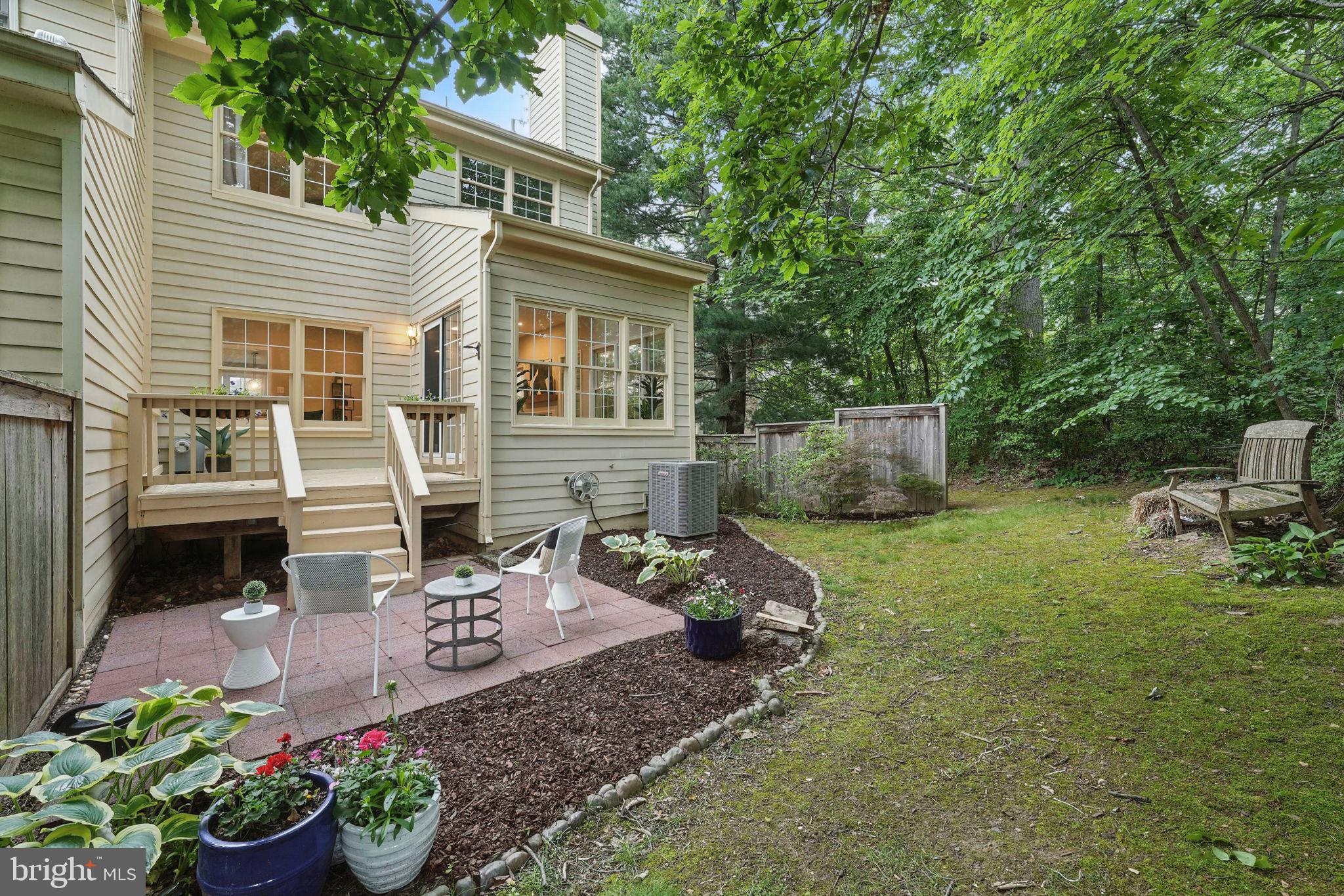 1393 Heritage Oak Way Reston, VA 20194 - Photo 42 of 80 a view of a backyard with table and chairs potted plants