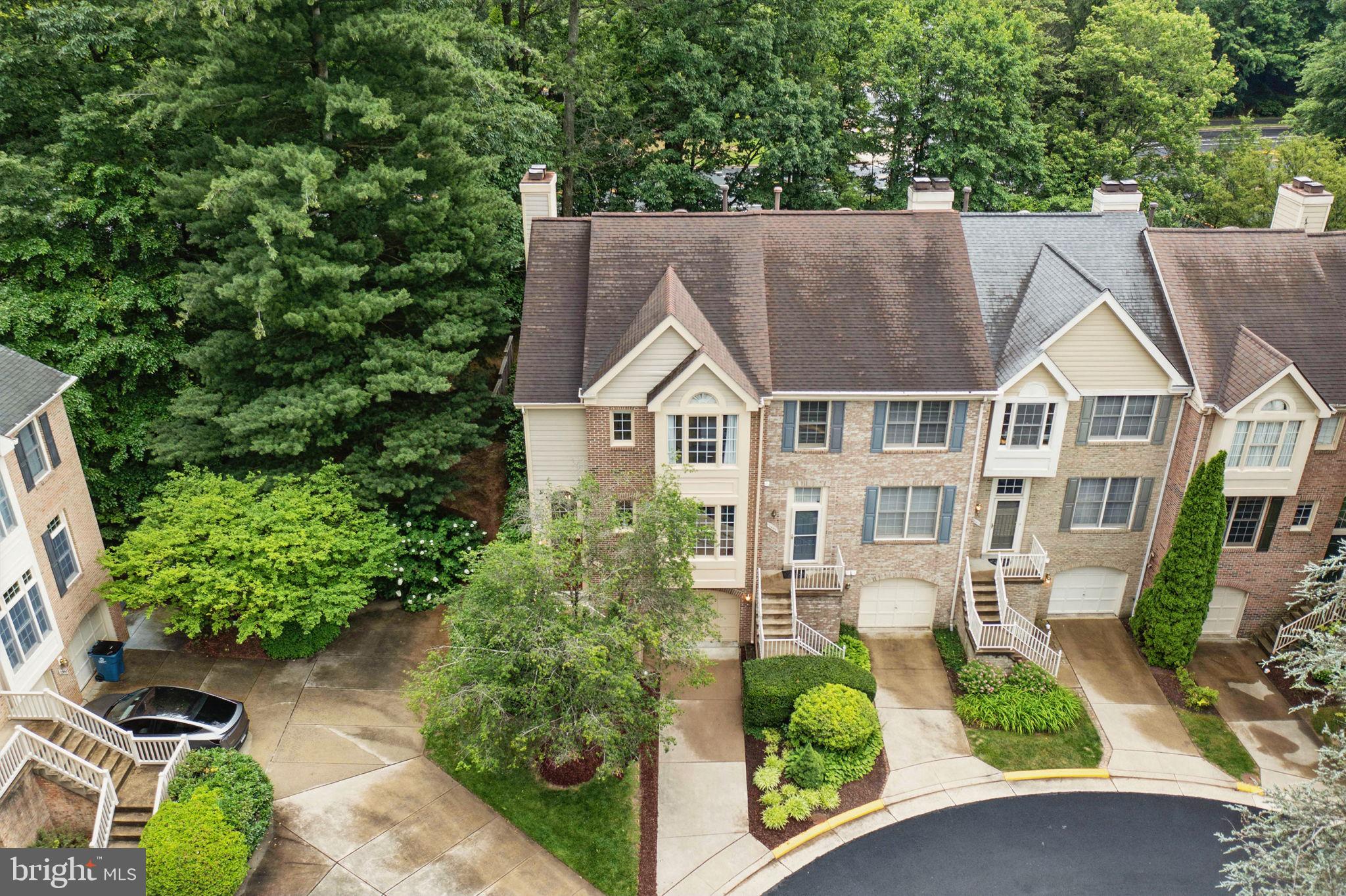 1393 Heritage Oak Way Reston, VA 20194 - Photo 44 of 80 a aerial view of a house with potted plants and large trees