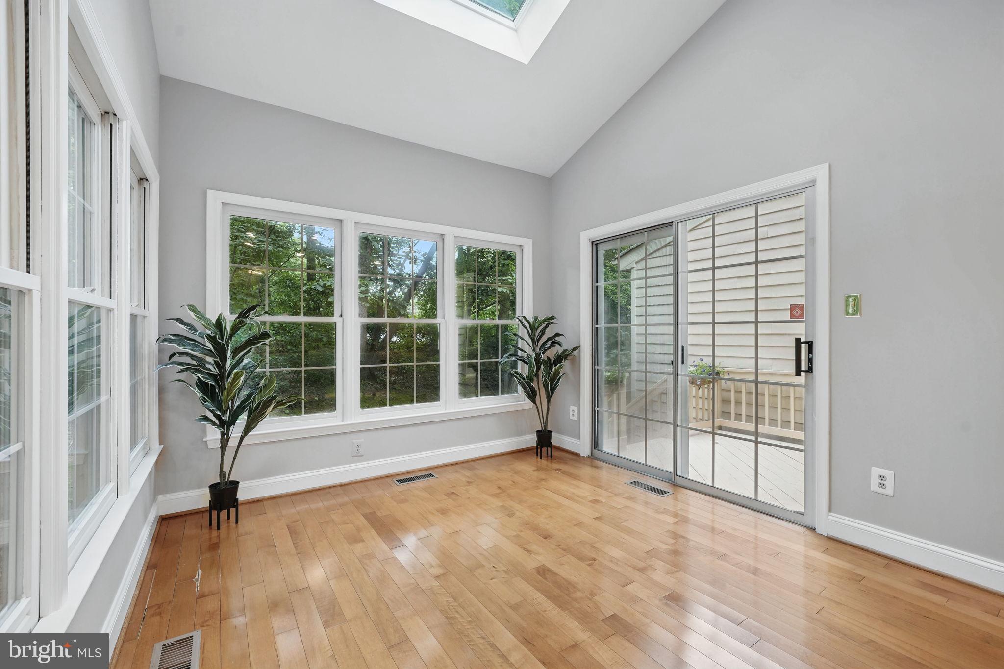 1393 Heritage Oak Way Reston, VA 20194 - Photo 9 of 80 a view of livingroom with wooden floor and floor to ceiling window