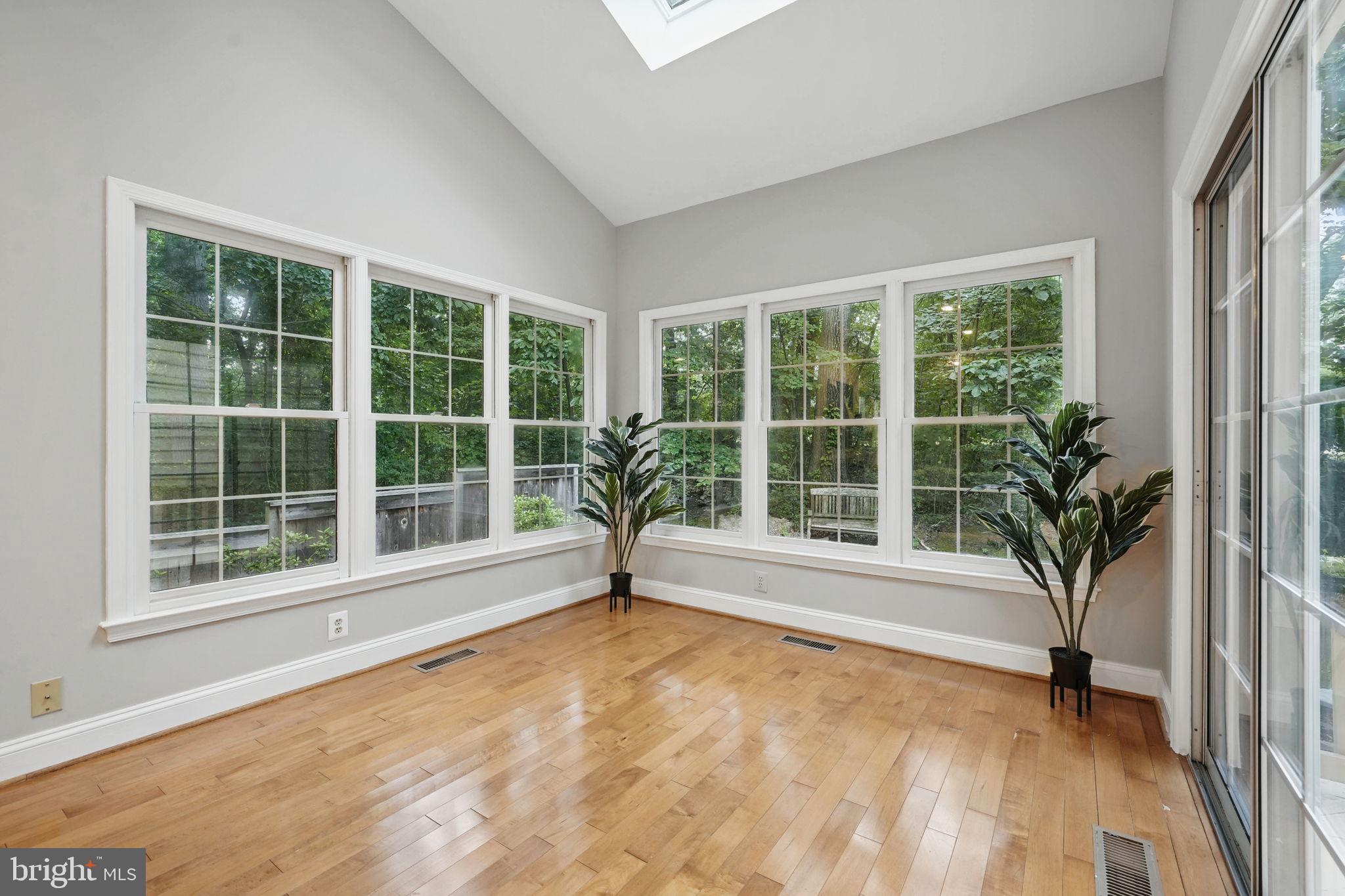 1393 Heritage Oak Way Reston, VA 20194 - Photo 10 of 80 a view of empty room with wooden floor and floor to ceiling window
