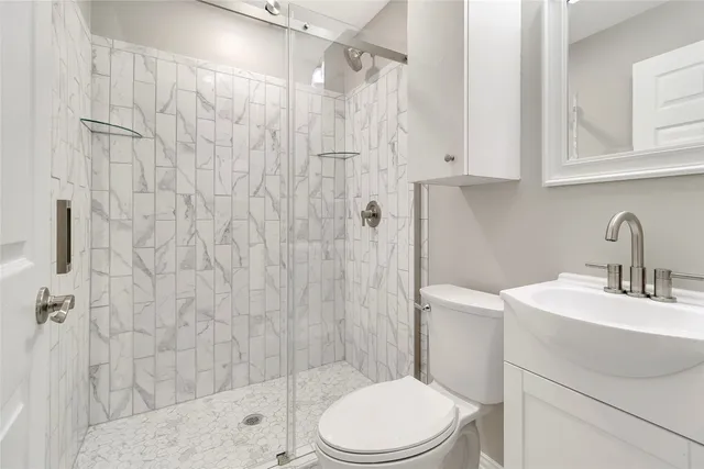 a bathroom with a sink toilet and shower