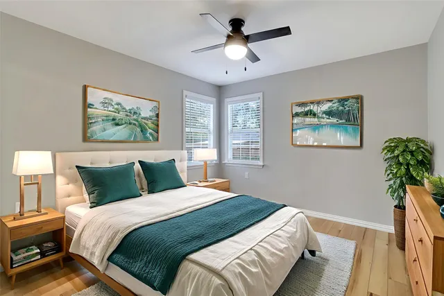 a bedroom with a large bed and a chandelier