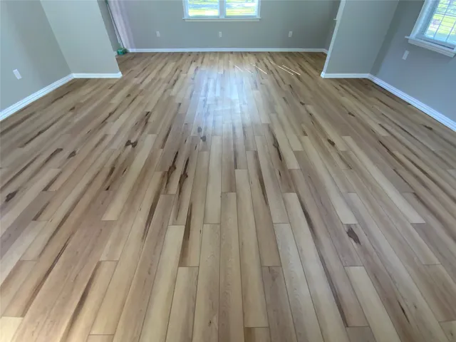 a view of room with window and wooden floor