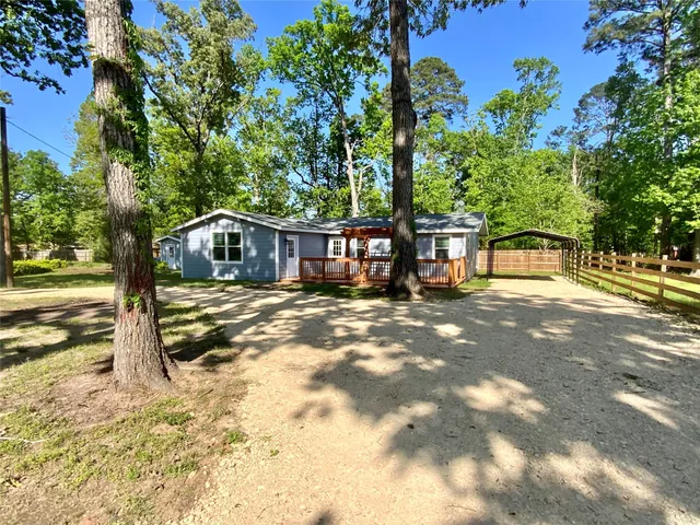 a view of a house with a tree in the yard
