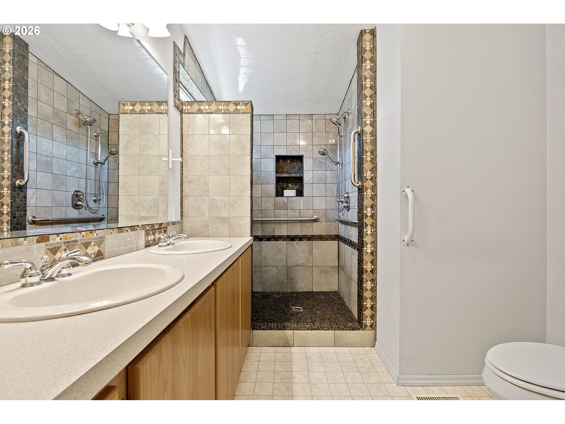 98041 Hallway Road, Unit 41 Brookings, OR 97415 - Photo 19 of 48 a bathroom with a sink a toilet a mirror and shower