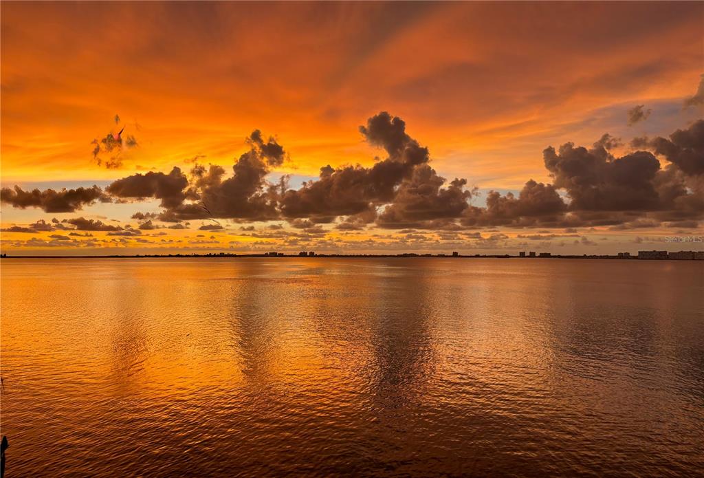 5279 Isla Key Boulevard South, Unit 417 St. Petersburg, FL 33715 - Photo 1 of 40 a view of an ocean with sunset